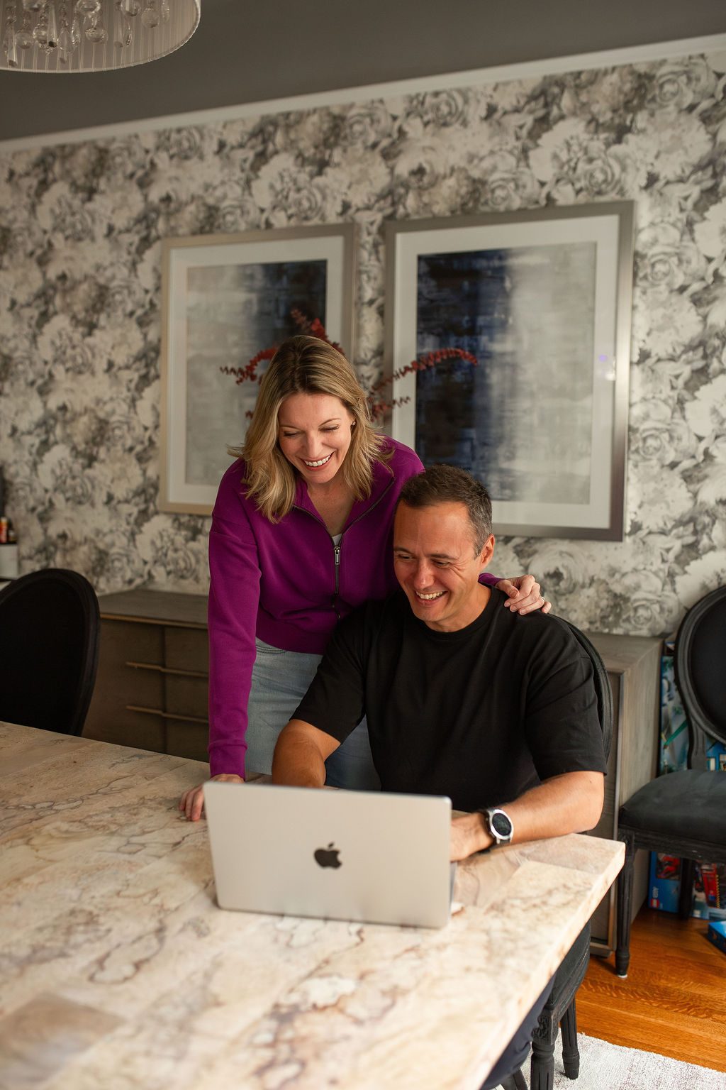 Dom and Shannon laughing together at the laptop