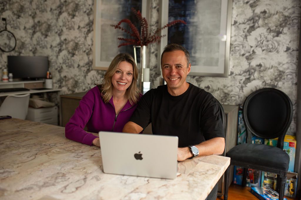 Dom and Shannon at their dining table, smiling