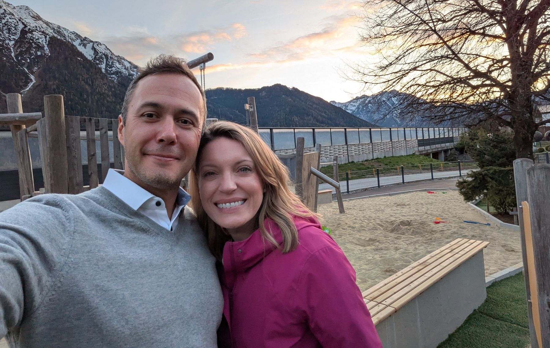 Dom and Shannon smiling together at sunset in the mountains